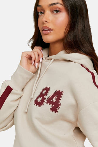 Gilet beige de TALLY WEIJL, avec '84' sur l'avant et un détail rayé sur le manche.