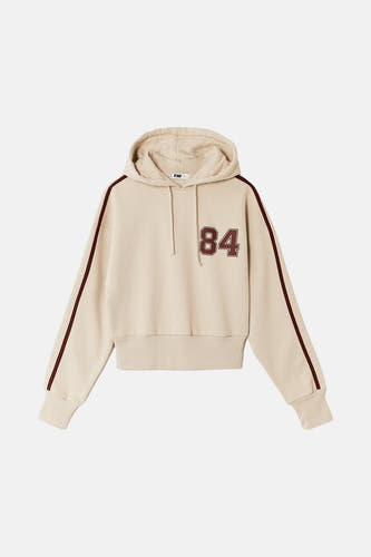 Gilet beige de TALLY WEIJL avec capuchon, manches longues avec des rayures rouges et le numéro 84.