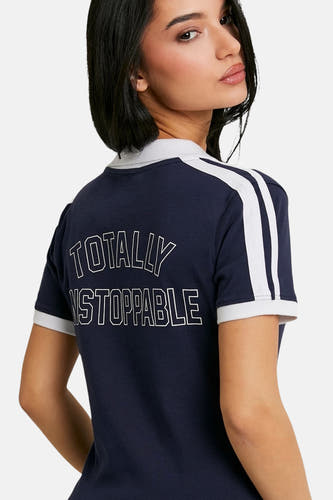 Polo bleu à manches courtes de TALLY WEIJL, avec des rayures blanches sur les épaules et le texte "TOTALLY UNSTOPPABLE" dans le dos.