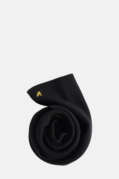 Zwarte wintersjaal van Lyle & Scott met een geborduurde adelaar en ribgebreide textuur, opgerold gepresenteerd.