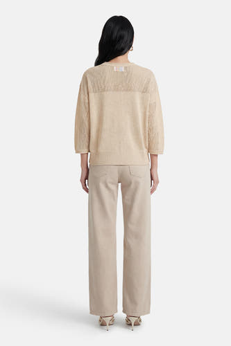 Ecru trui van ADORE, met open breisel en gedragen met een beige broek en stiletto's.
