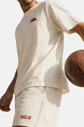 Ecru korte mouw t-shirt van BASELAB met klein rood logo, lifestyle shot, model met basketbal, zachte stof, casual fit