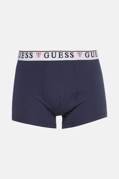 Boxer short bleu marine de Guess, avec une ceinture blanche à logo de marque.