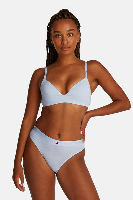 Blauwe beha van TOMMY JEANS, gedragen door een vrouw met gevlochten haar en een bijpassende slip.
