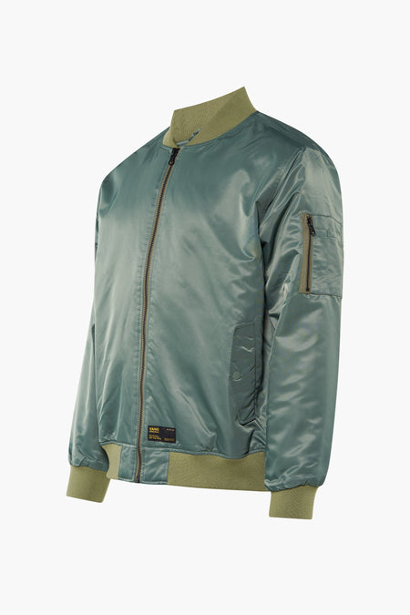 Groene korte jas van VANS 'OFF THE WALL' van glanzend nylon met olijfgroene geribde boorden en mouwzak.