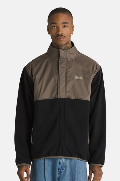 Gilet en polaire marron de VANS avec partie inférieure noire, col montant et logo VANS sur la poitrine.