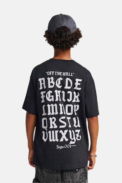 Zwart T-shirt met korte mouwen van VANS “OFF THE WALL”, met witte letters op de achterkant en een grijze pet.