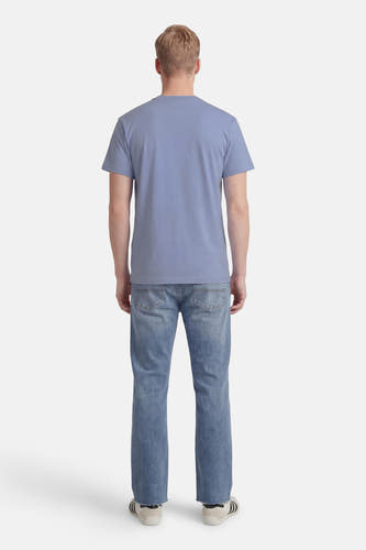 Blauw T-shirt met korte mouwen van VANS “OFF THE WALL”, gezien van achteren met jeans en sneakers.