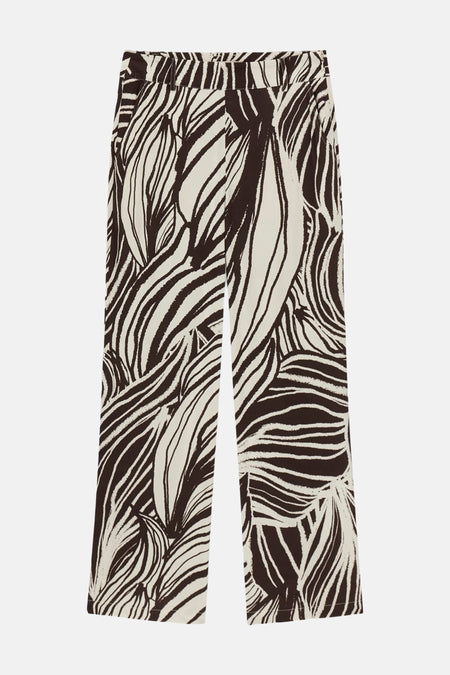 Crèmekleurige broek met abstract bladmotief van Guess®, met wijde pijpen, platliggend.